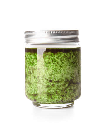 Jar with fresh pesto sauce on white backgroundの写真素材