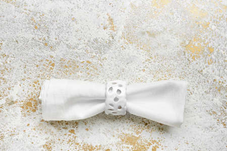 Fabric napkin with ring on grunge backgroundの写真素材