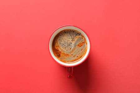 Cup of coffee on red backgroundの写真素材