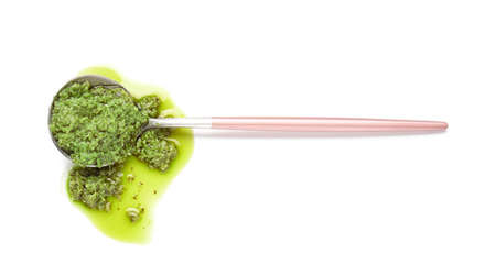 Spoon with fresh pesto sauce on white backgroundの写真素材