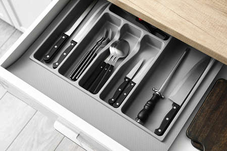 Drawer with set of knives in kitchenの写真素材