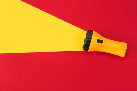 Creative composition with modern flashlight on color background