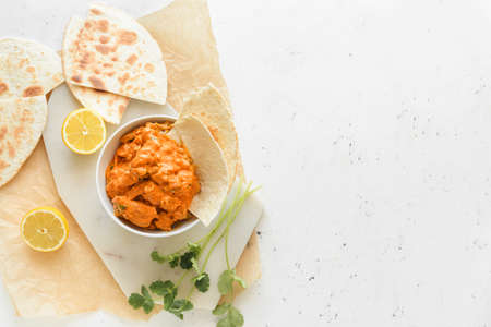 Bowl of tasty chicken tikka masala on white backgroundの写真素材