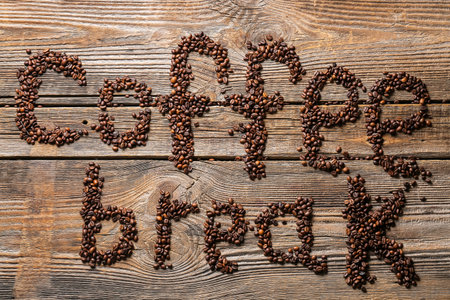 Text COFFEE BREAK made of coffee beans on wooden backgroundの写真素材