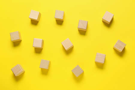 wooden cubes on color background