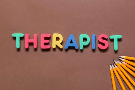 Word THERAPIST and pencils on color backgroundの写真素材