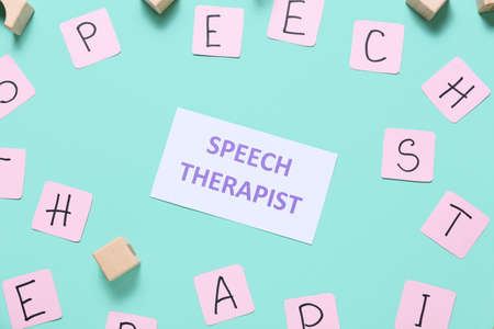 Paper with text SPEECH THERAPIST and letters on color backgroundの写真素材