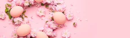 Beautiful Easter eggs with flowers on color background with space for textの写真素材