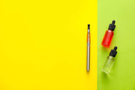 Electronic cigarette with oil on color backgroundの写真素材
