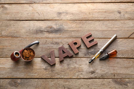 Set smoking with word VAPE on wooden background