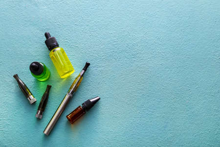 Electronic cigarette with oil on color backgroundの写真素材