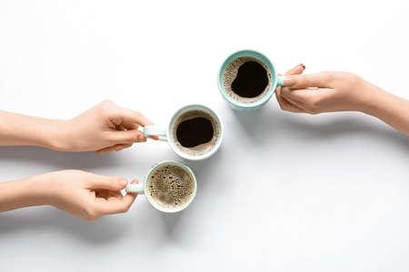 Women with cups of coffee on white backgroundの写真素材