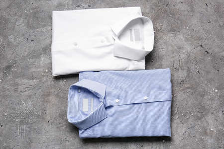 Stylish male shirts on grunge background