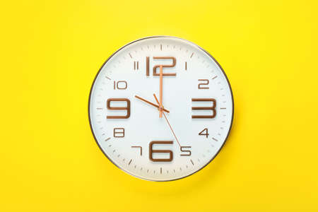Stylish clock on color background