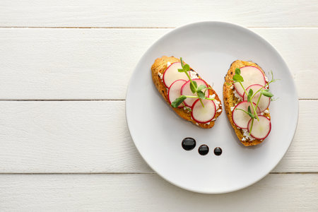 Tasty bruschettas with cheese and radish on light wooden backgroundの写真素材