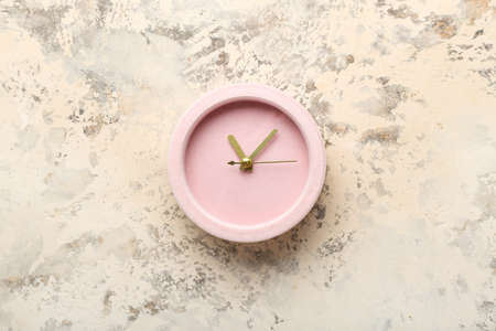 Stylish alarm clock on grunge background