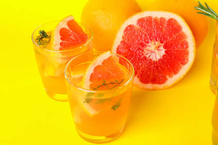 Glasses of tasty grapefruit lemonade on color backgroundの写真素材