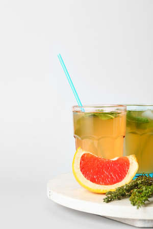 Glasses of tasty grapefruit lemonade on white backgroundの写真素材