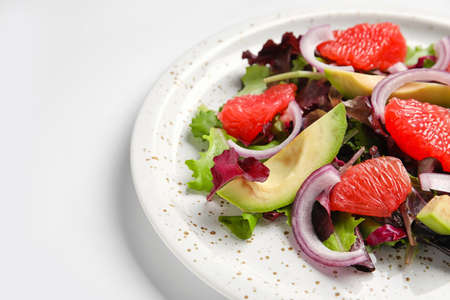 Plate with tasty grapefruit salad on white background, closeup