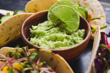 Tacos and tasty guacamole in bowl, closeupの写真素材