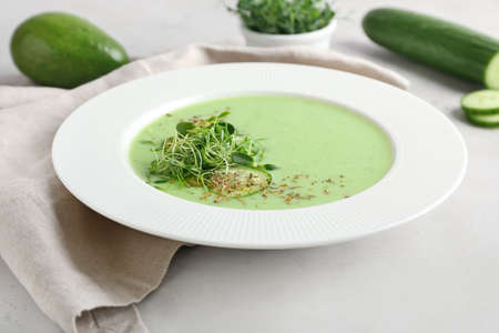 Plate with green gazpacho on light backgroundの写真素材