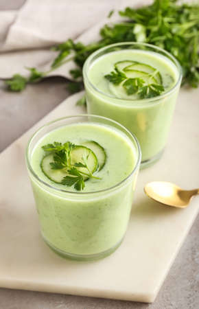 Glasses with green gazpacho on gray backgroundの写真素材
