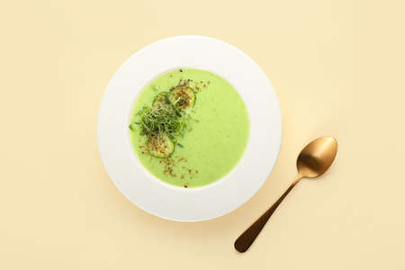 Plate with green gazpacho on color backgroundの写真素材