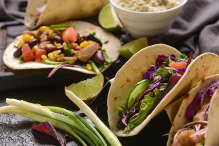 Tacos and tasty guacamole in bowl on table, closeupの写真素材