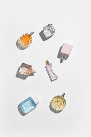 Composition with different bottles of elegant perfumes on white backgroundの写真素材