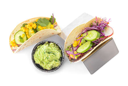 Stand with tacos and tasty guacamole in bowl on white backgroundの写真素材