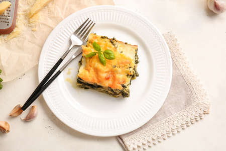 Plate with tasty green lasagna on tableの写真素材
