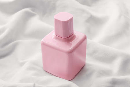 Perfume bottle on white background, closeup