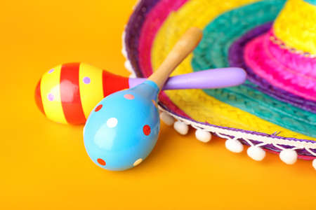 Mexican maracas and sombrero on color backgroundの写真素材