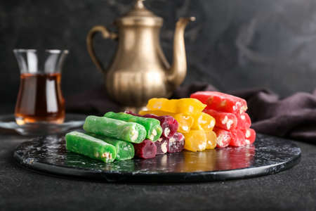 Board with tasty Turkish delight on tableの写真素材