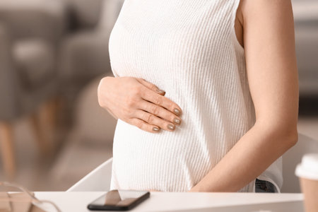 Pregnant businesswoman working at home