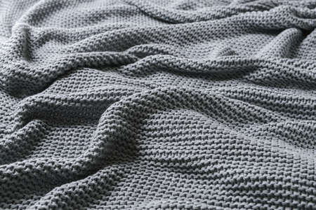 Texture of gray knitted plaid, closeup