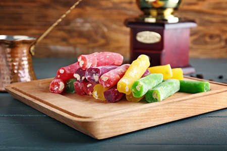 Board with tasty Turkish delight on tableの写真素材