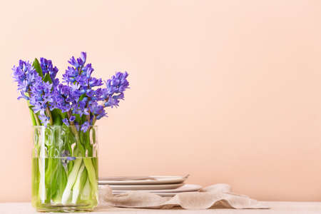 Vase with beautiful hyacinth flowers on dining tableの写真素材