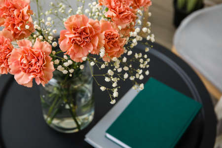 Bouquet of beautiful carnation flowers on table in room, closeupの写真素材