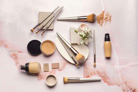 Set of makeup brushes with decorative cosmetics on light backgroundの写真素材