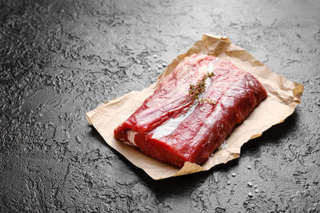 Raw beef brisket on dark background