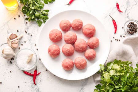 Composition with raw cutlets made of fresh forcemeat on light backgroundの写真素材
