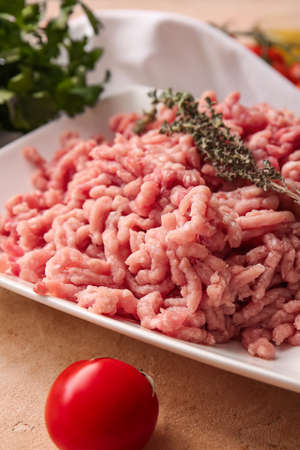 Plate with fresh forcemeat on table, closeup