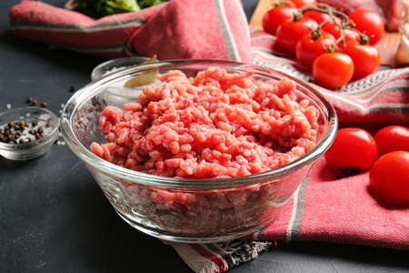 Bowl with fresh forcemeat on dark background