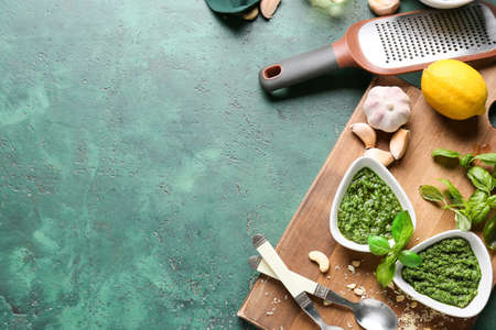 Composition with tasty pesto sauce on color backgroundの写真素材