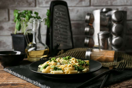 Plate with tasty pasta and pesto sauce on tableの写真素材