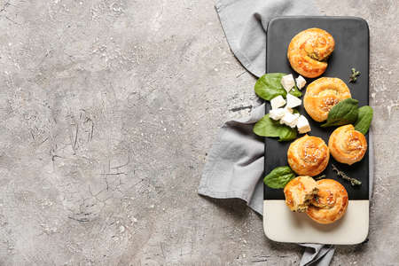 Puff pastry stuffed with spinach and feta cheese on grunge background