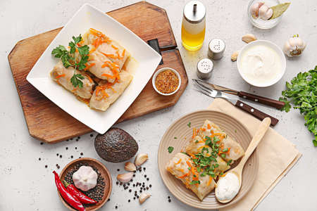 Plates with tasty stuffed cabbage rolls on light backgroundの写真素材