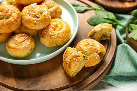 Puff pastry stuffed with spinach on boardの写真素材