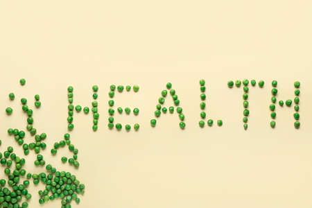 Word HEALTH made of green peas on beige backgroundの写真素材